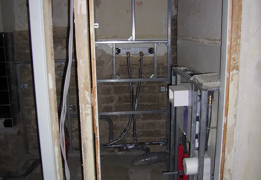 WC-Vorwandtechnik im Rohbau mit Spuelkasten und Leitungen
